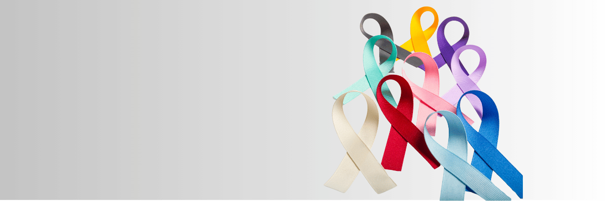 Stock photo of different colored cancer awareness ribbons on a gray background. 
