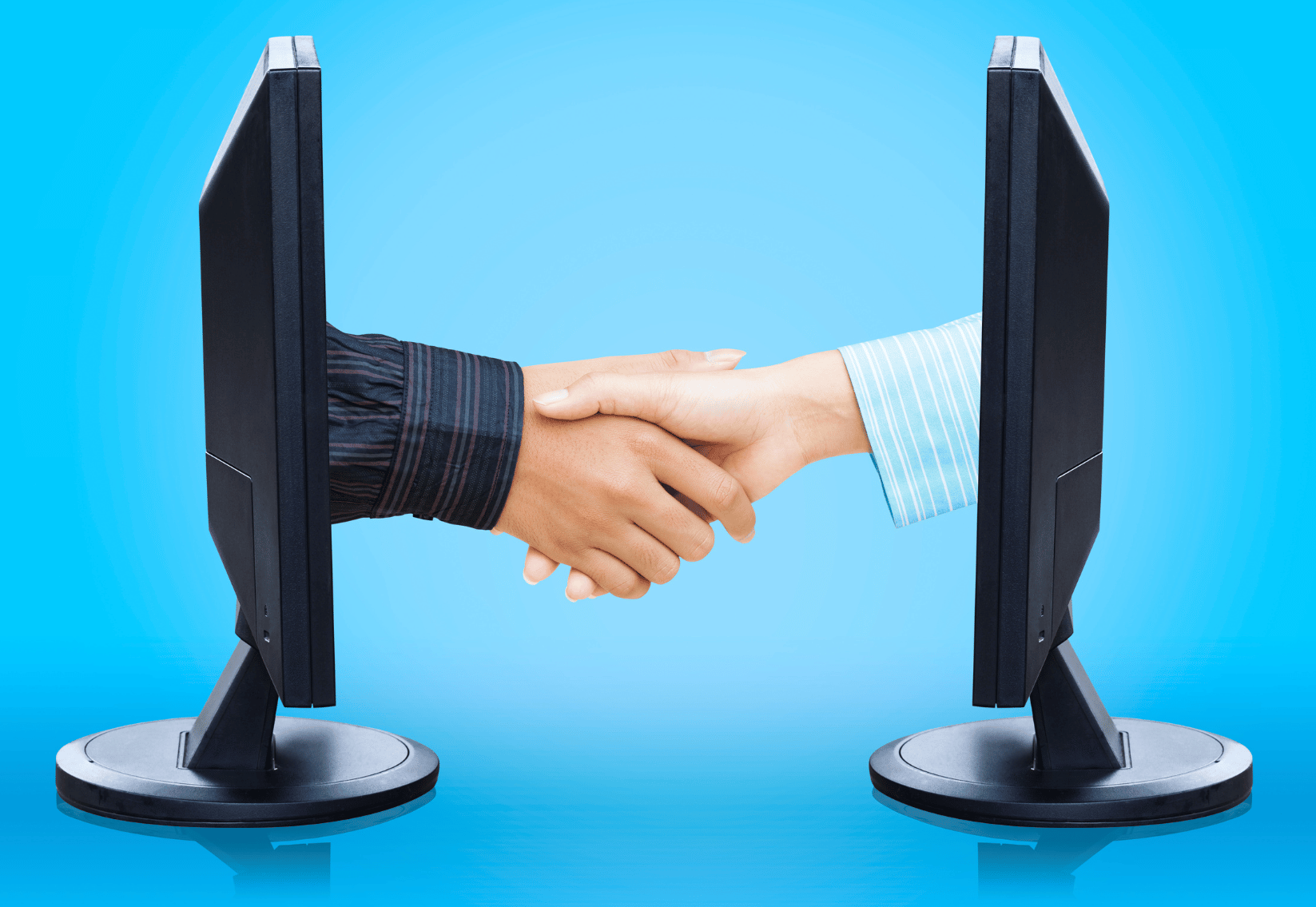 Graphic photo of handshaking through computer monitors