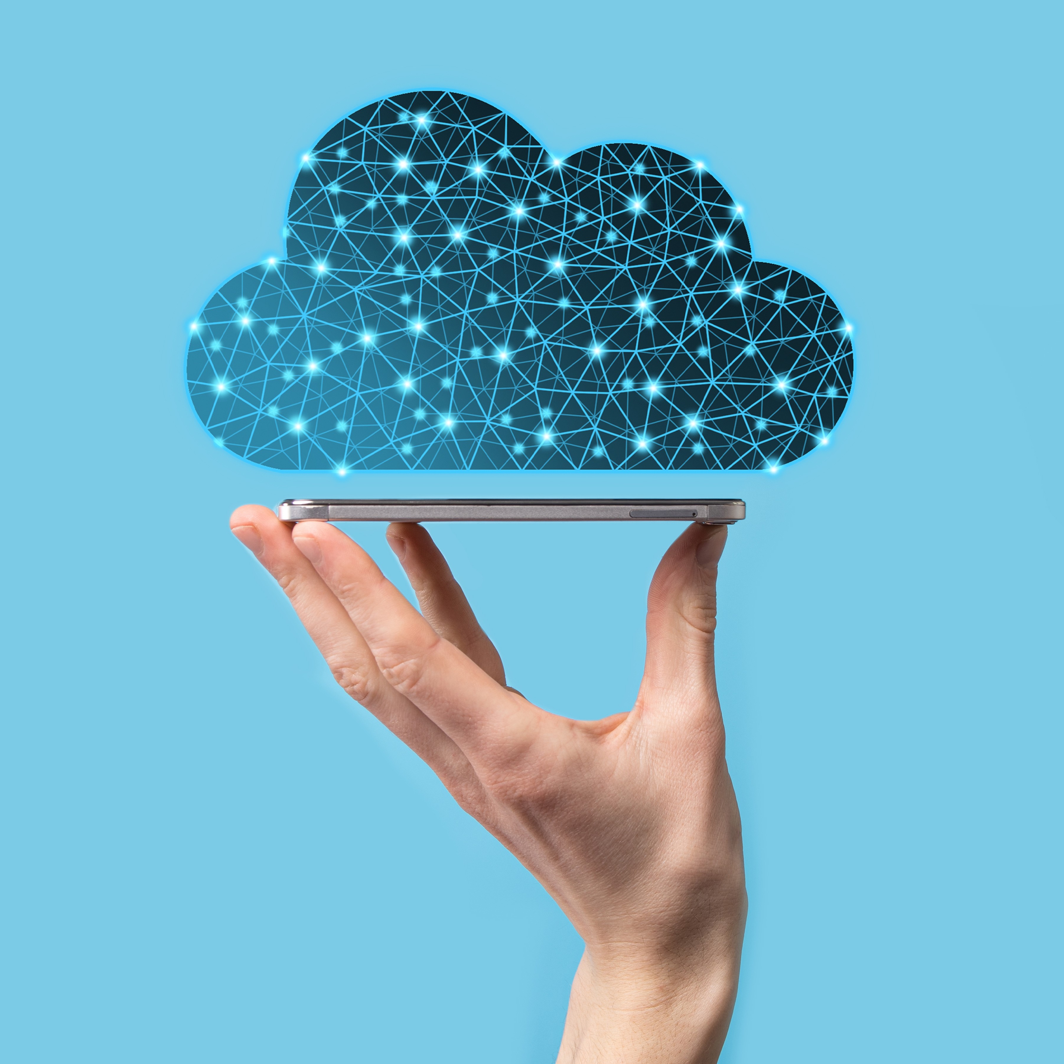 Image of a hand holding up a smartphone with a digital cloud floating above it