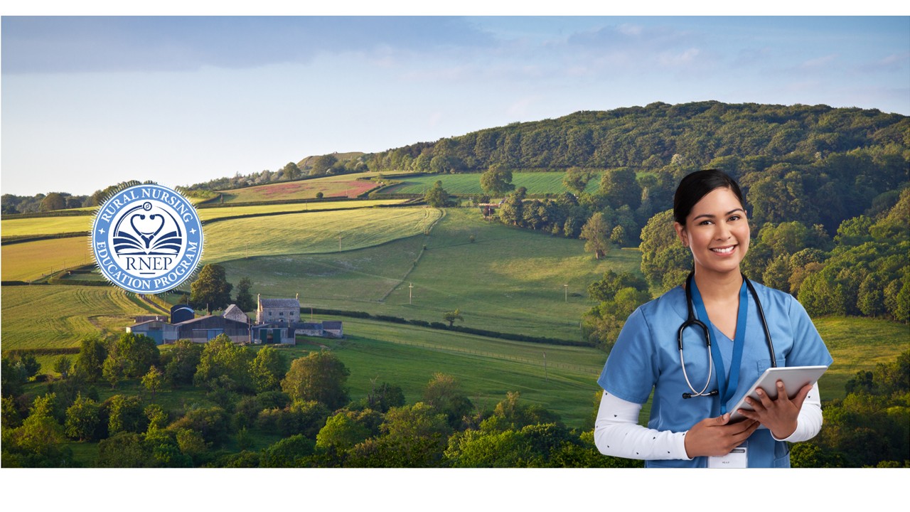 Young female nurse in blue scrubs wearing stethoscope smiles holding tablet in front of vast rural background showing a home and green fields.