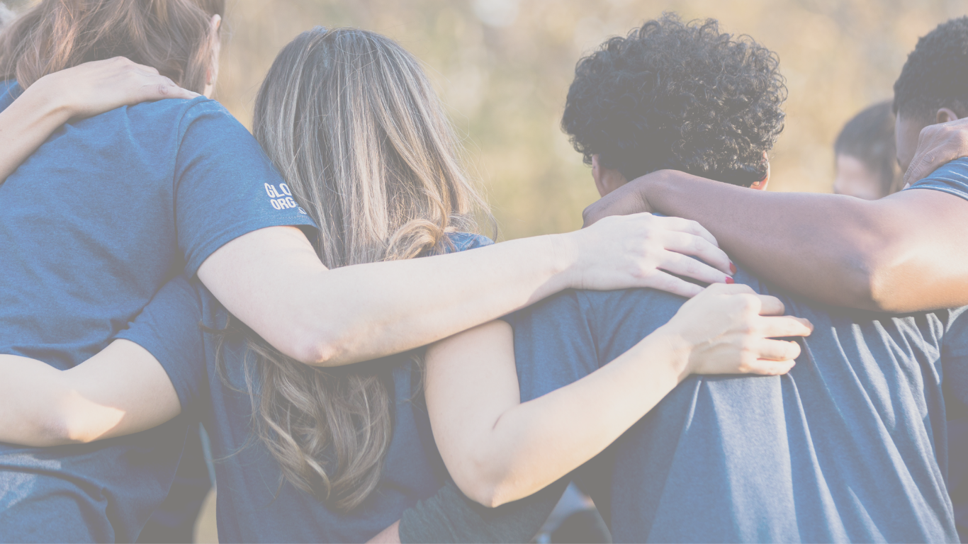 young people with their arms around each other's shoulders