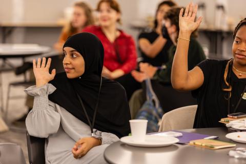 YAC members raise their hands at orientation meeting.