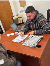 Latino male working at table
