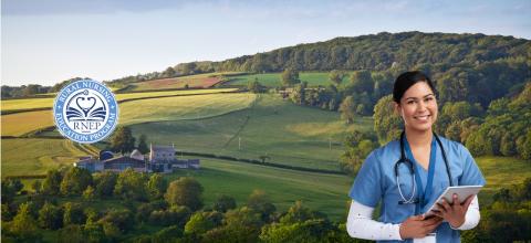 Young female nurse in blue scrubs wearing stethoscope smiles holding tablet in front of vast rural background showing a home and green fields.